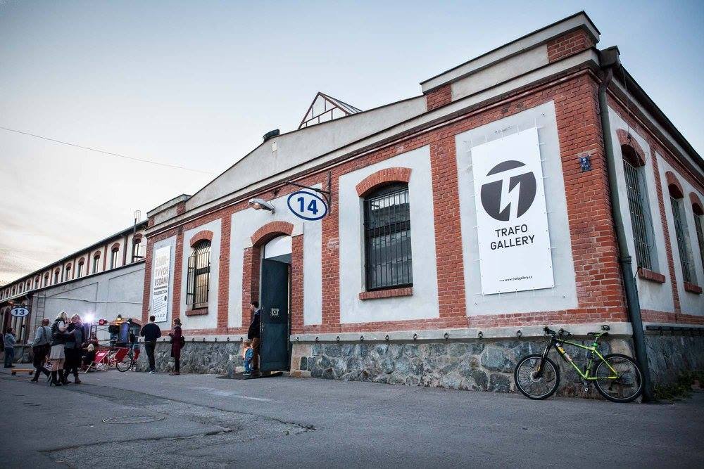 A red-and-white brick building, with people in front of it