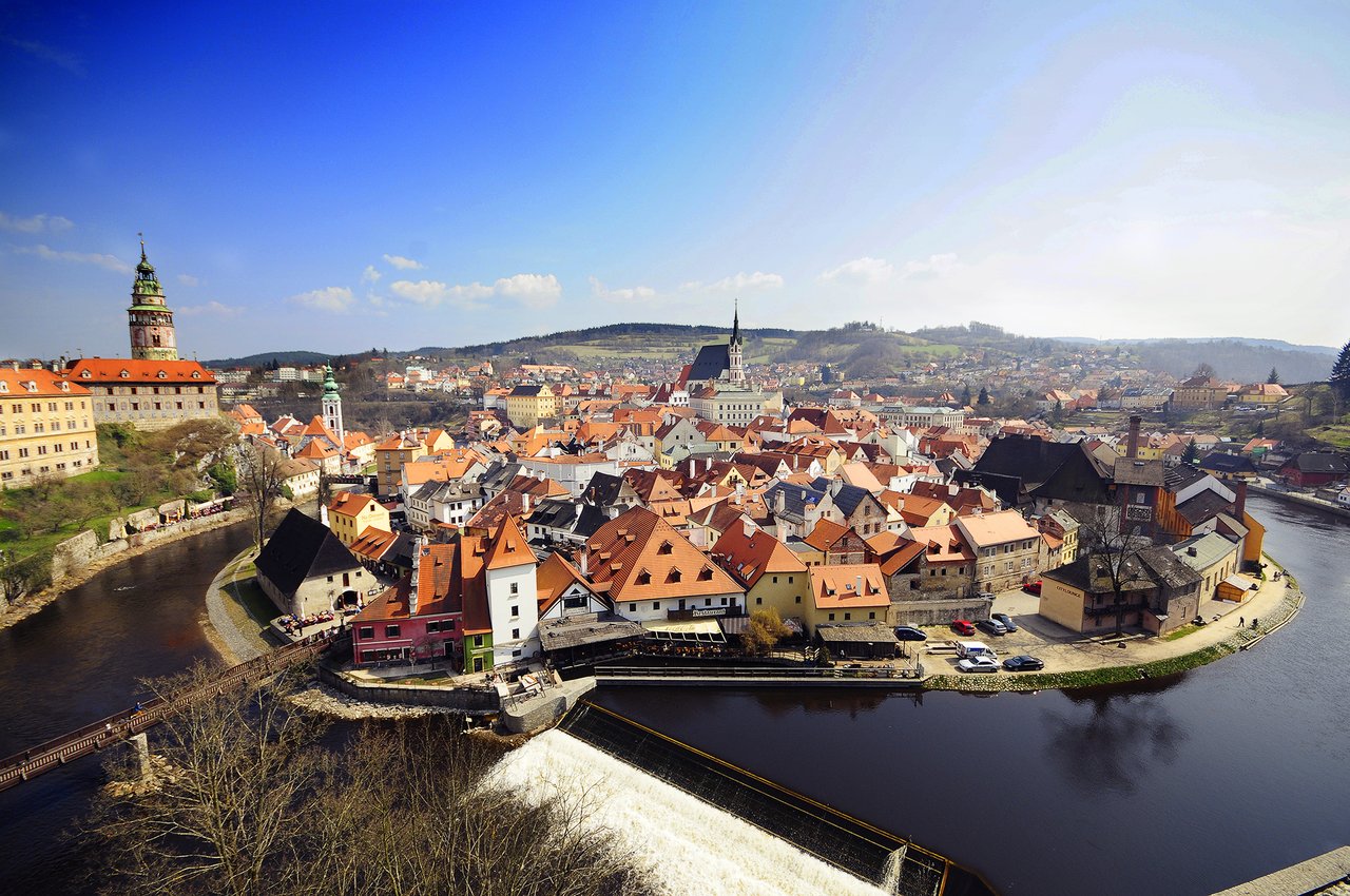 This panoramic view of the medieval town, where a multitude of houses with bright orange-tiled roofs are crammed together