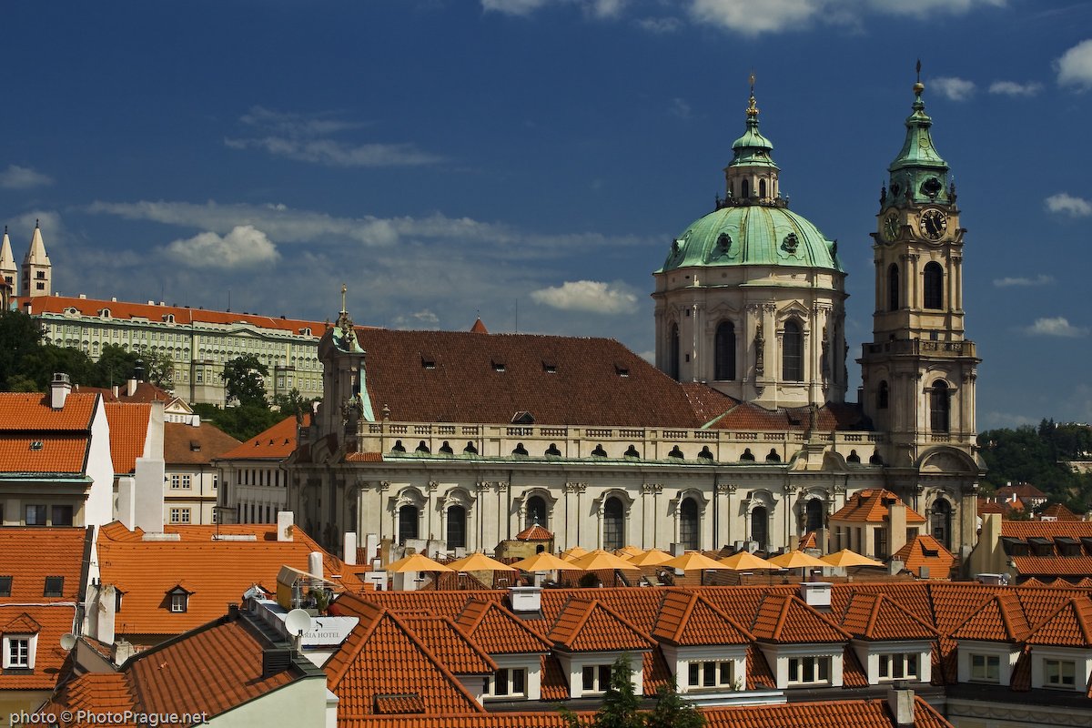 View of the large church with its green dome and orange roofs