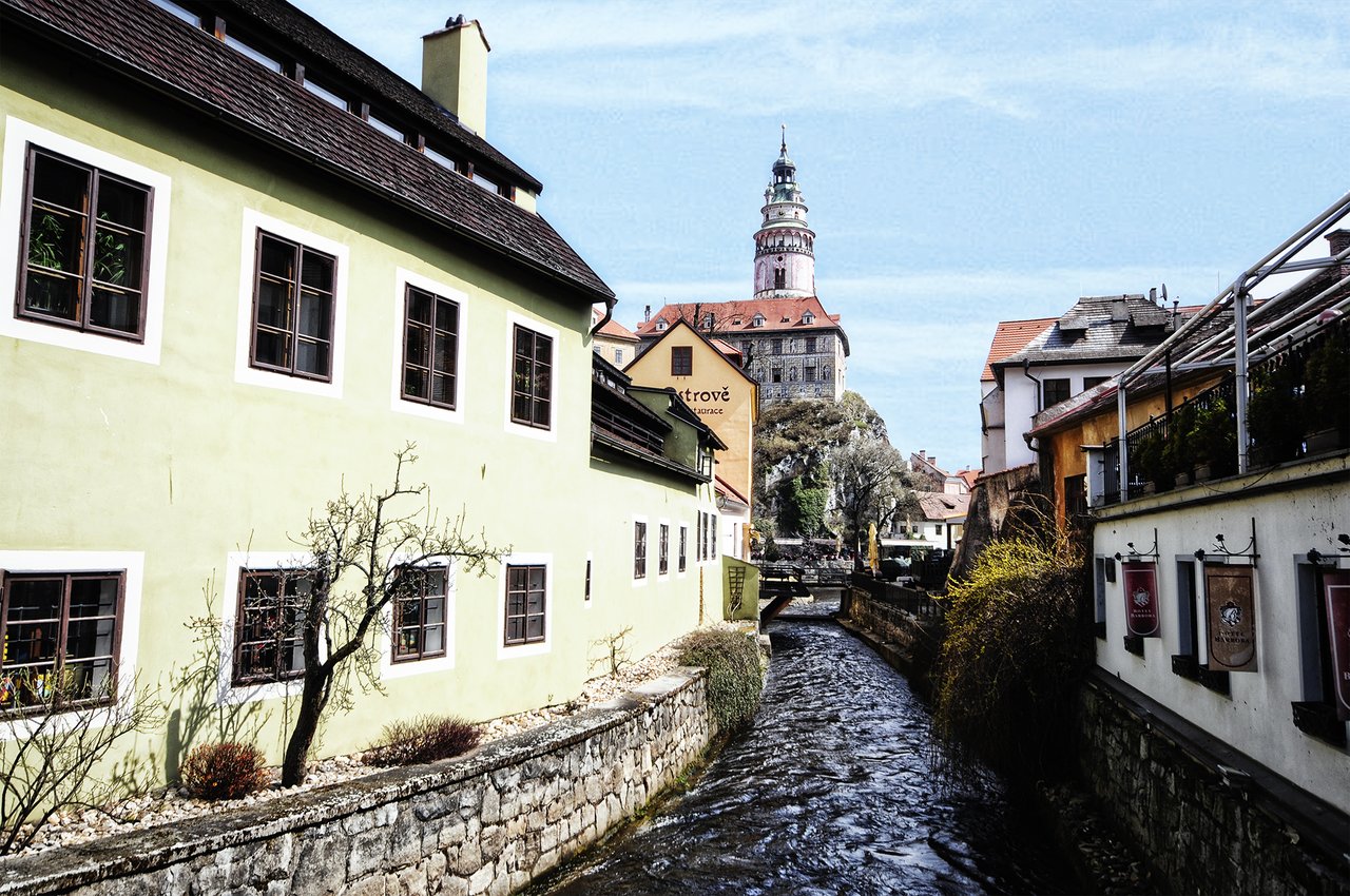 A small river runs through the center, lined with colorful houses with sloping roofs