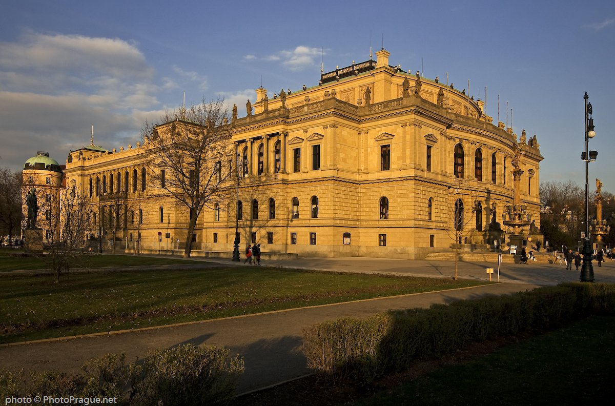 A large building with Neo-Renaissance architecture, bathed in sunlight