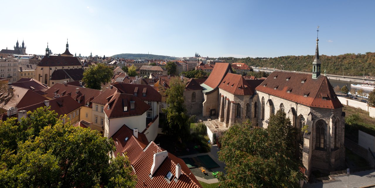 Aerial view of old buildings with red roofs under a blue sky
