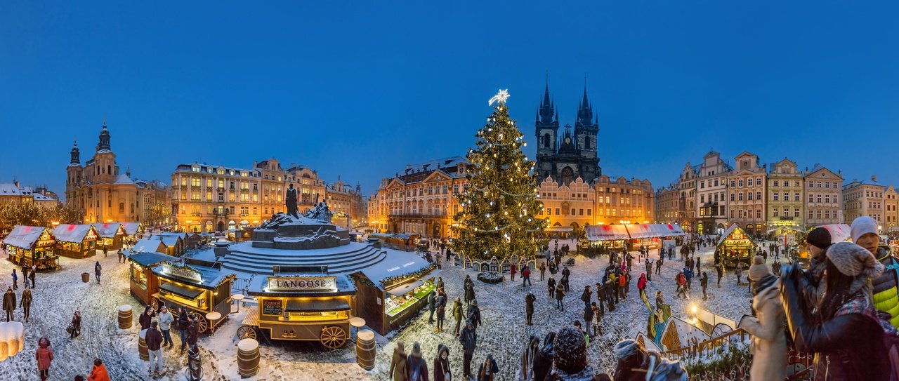 A large Christmas market with a big decorated Christmas tree in the center